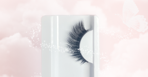 Image of a single false strip lash in a white tray, featuring a flicked-up, flat winged design for added length and volume